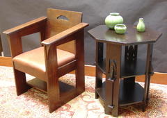 Shown next to a replica Limbert Cafe chair.